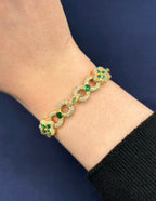 10K Gold Infinity Flower Diamond & Green Gemstone Bracelet in yellow gold - close-up product photo