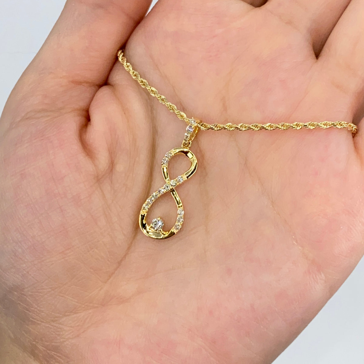 10K Gold Diamond Infinity Pendant in yellow gold - close-up product photo
