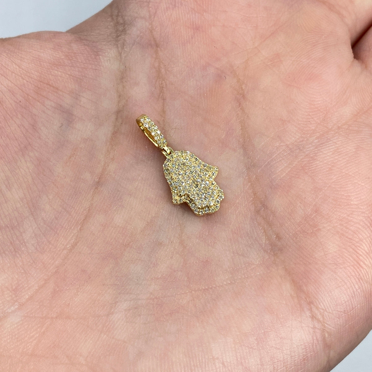 14K Gold Dainty Hamsa Diamond Pendant in yellow gold - close-up product photo
