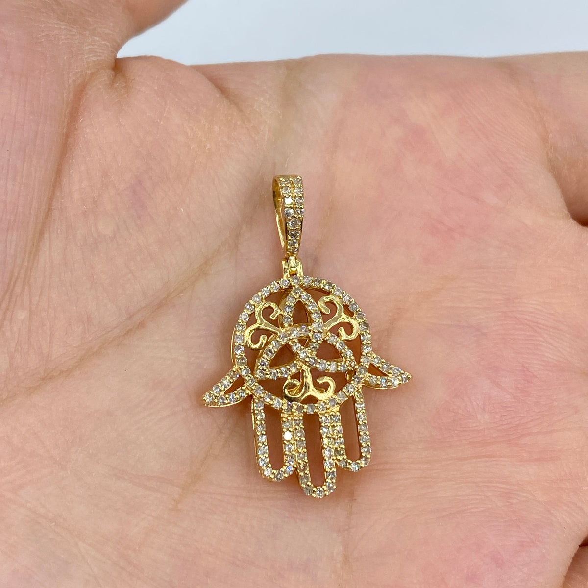 14K Gold Floral Hamsa Diamond Pendant in yellow gold - close-up product photo