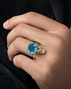 Male model wearing 10k Yellow Gold Cocktail Ring with Oval Aquamarine Cabochon