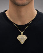 Male model wearing 10K Gold and White Saphire Diamond Shape Pendant