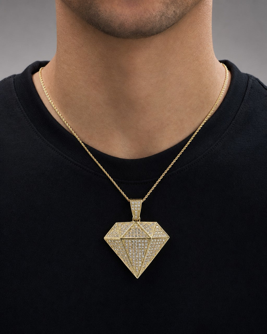 Male model wearing 10K Gold and White Saphire Diamond Shape Pendant