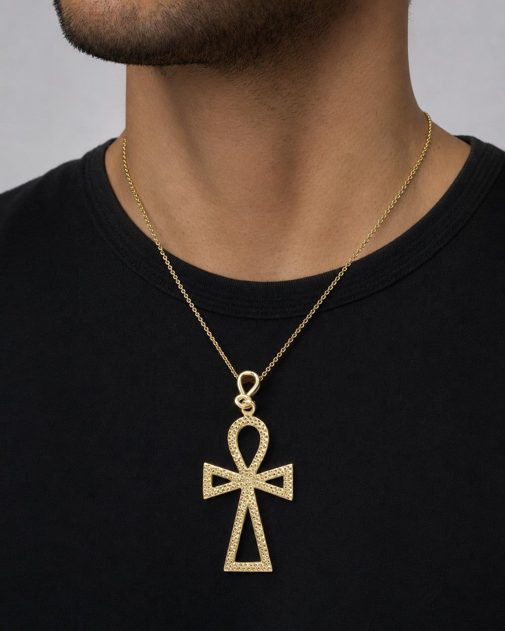 Male model wearing 10k gold ankh pendant
