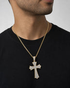 Male model wearing 10k cross pendant with white sapphire ￼