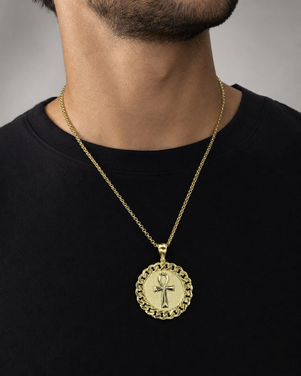 Male model wearing 10k cuben style ankh circle ￼pendant