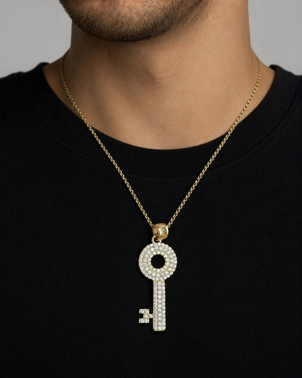 Male model wearing 10K Gold White Sapphire Stone Key Pendant
