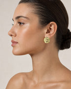 Female model wearing 18K Gold Wavy Circle Earrings