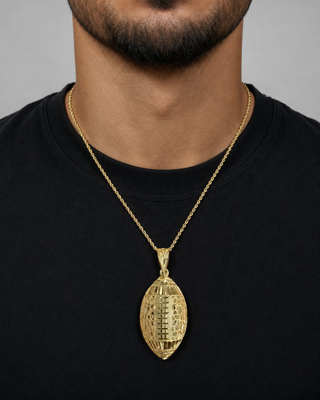 Male model wearing 10K Gold Football Pendant