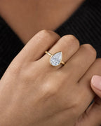 Female model wearing 14k Enclosed Pear Center Stone Lab Diamond Engagement Ring