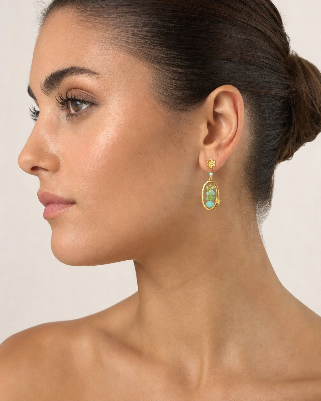 Female model wearing 18K Gold hanging colorful earrings