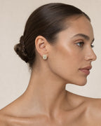 Female model wearing 10K Rectangle Earrings with Baguette Center