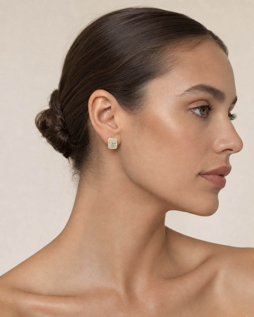 Female model wearing 10K Rectangle Earrings with Baguette Center