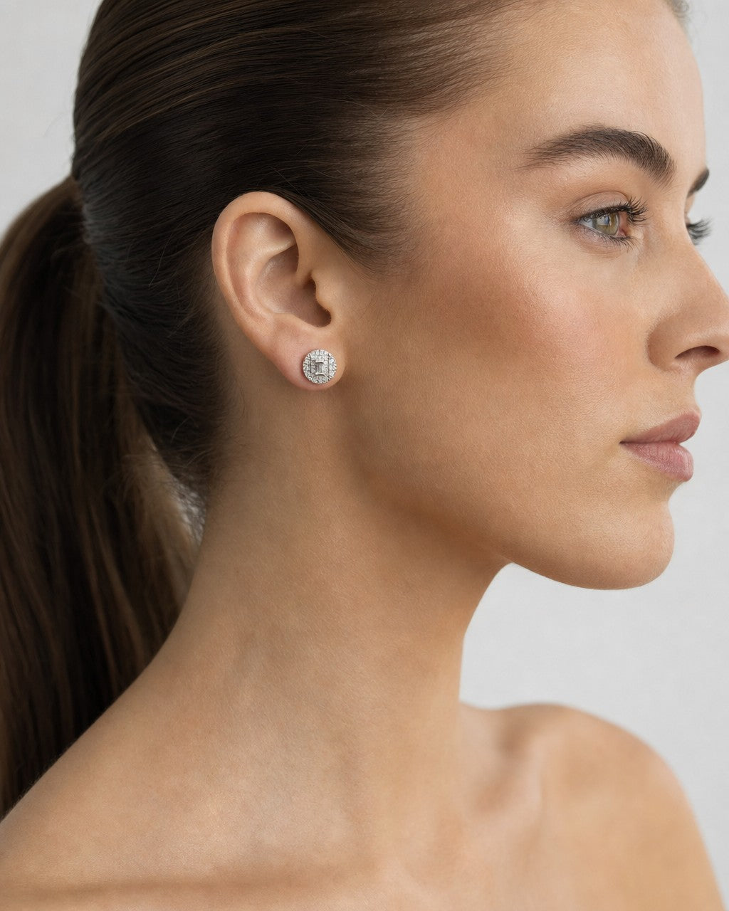 Female model wearing 10K Stacked Baguette Center Cake Earring