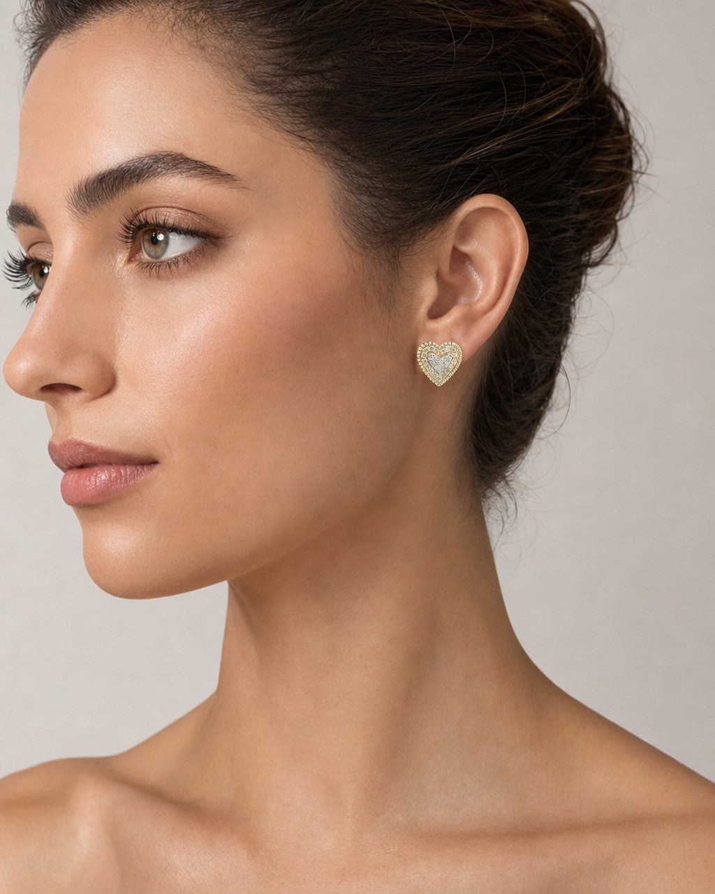 Female model wearing 10k Layered Lavish Heart Earrings