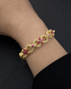 Male model wearing 10K Gold Infinity Flower Diamond & Pink Gemstone Bracelet