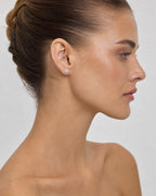 Female model wearing 14K Flower Diamond Earrings