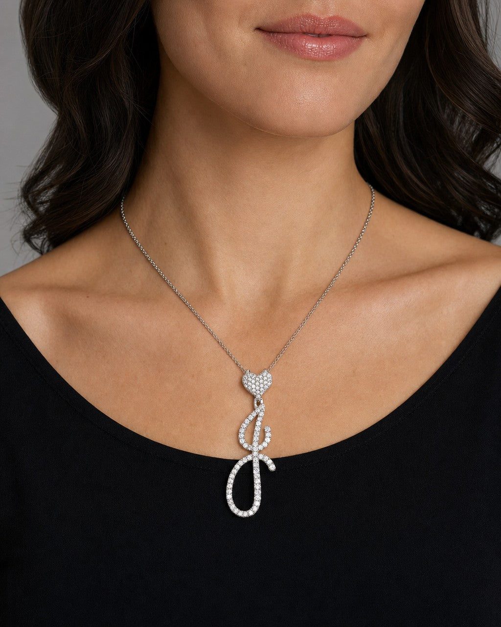Female model wearing 14K Initial J Script Heart Diamond Pendant