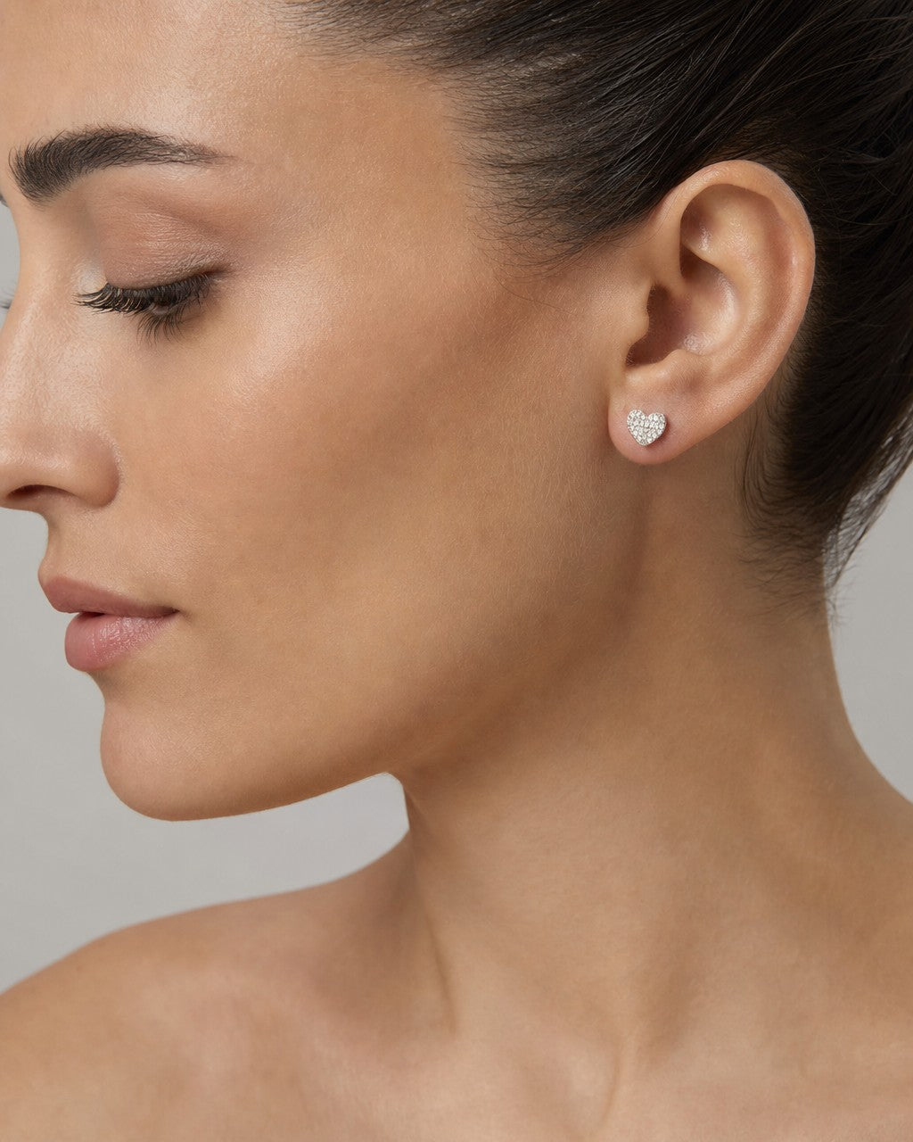 Female model wearing 10K Festive Heart Earrings