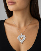 Female model wearing 10K Triple-Row Baguette Heart Pendants