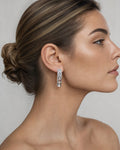 Female model wearing 14k Large Baguette Square Style Hoop Earrings