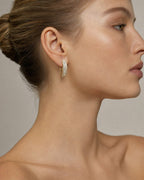 Female model wearing 14k Baguette Gap Hoop Earrings
