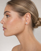 Female model wearing 10K Sunflower Diamond Baguette Earrings