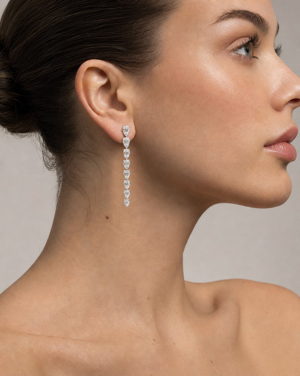 Female model wearing 14K Bridal Large Graduated Baguette Tear Drop Earrings
