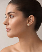 Female model wearing 10K Titan Circle Baguette Diamond Earrings
