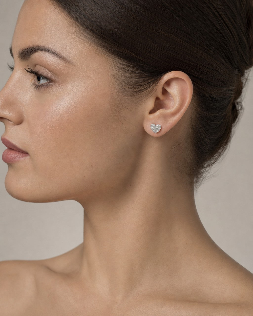 Female model wearing 14K Festive Heart Earrings