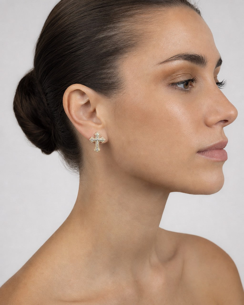 Female model wearing 14K Small Cross Earrings