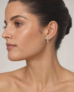 Female model wearing 14K Large Cross Earrings