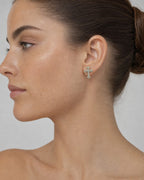 Female model wearing 10K Cross Earrings