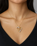 Female model wearing 10K Gold & Diamond Double Heart Pendant