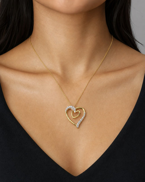 Female model wearing 10K Gold & Diamond Double Heart Pendant