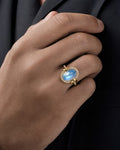 Male model wearing 18K Gold & Diamond Oval Moonstone Ring