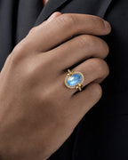 Male model wearing 18K Gold & Diamond Oval Moonstone Ring