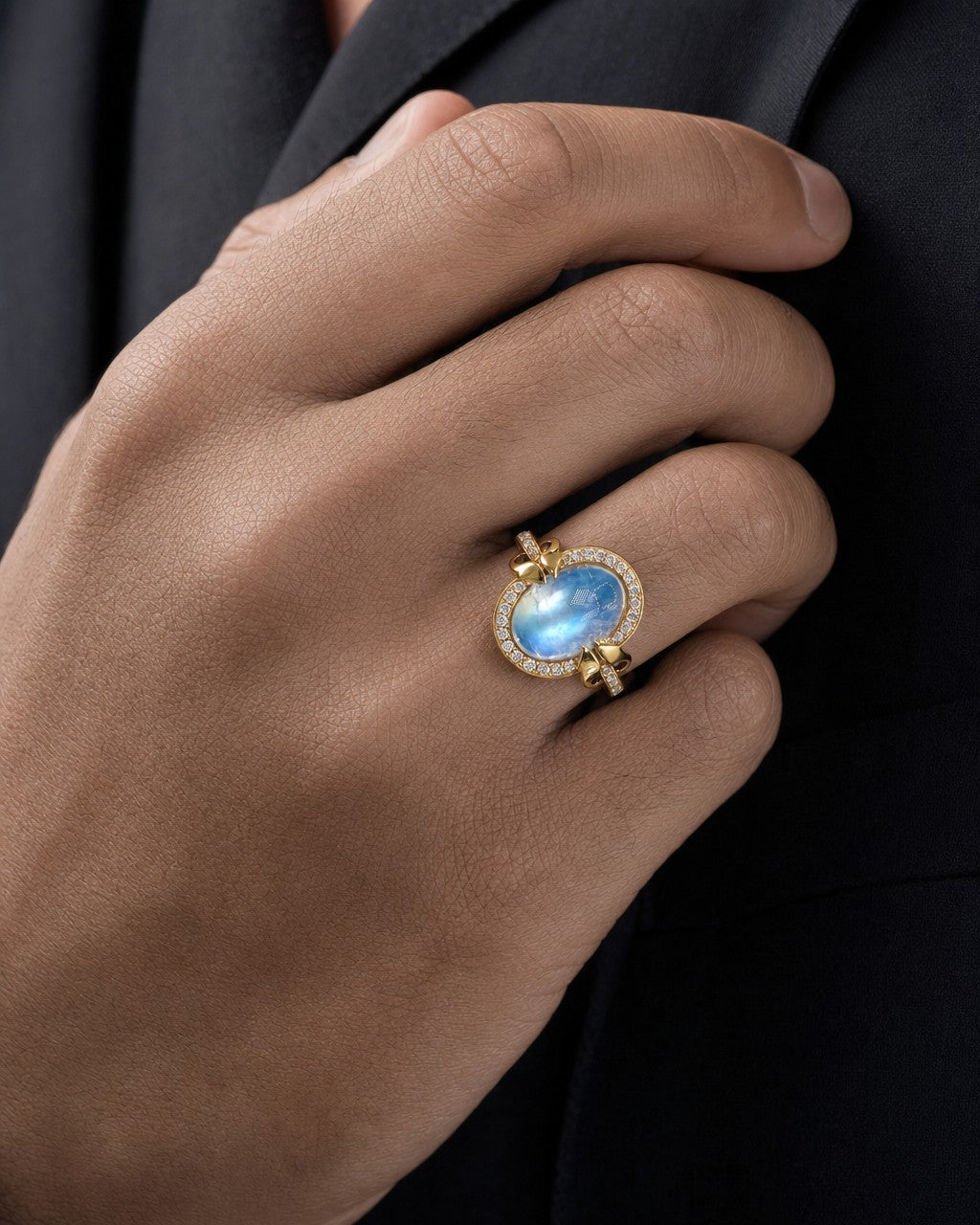 Male model wearing 18K Gold & Diamond Oval Moonstone Ring