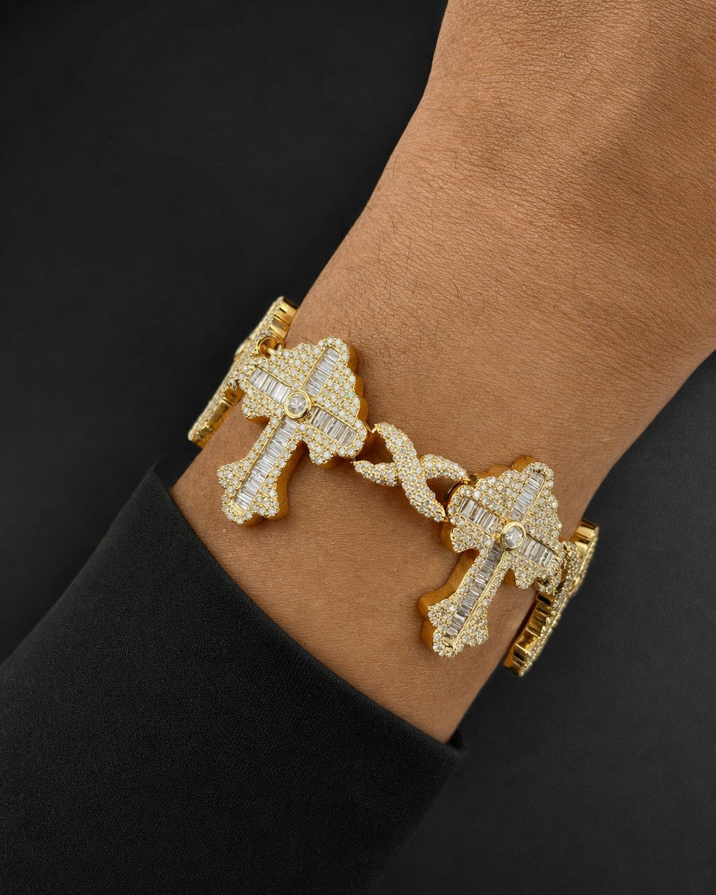 Male model wearing 10k Baguette Cross Infinity Bracelet