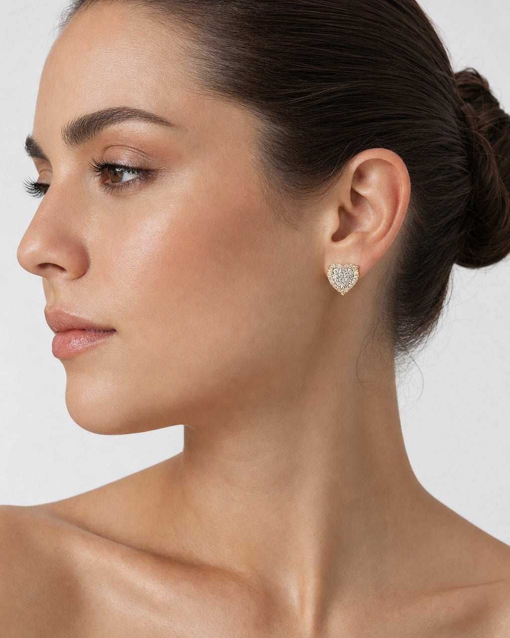 Female model wearing 14K Halo Heart Iced Diamond Earrings