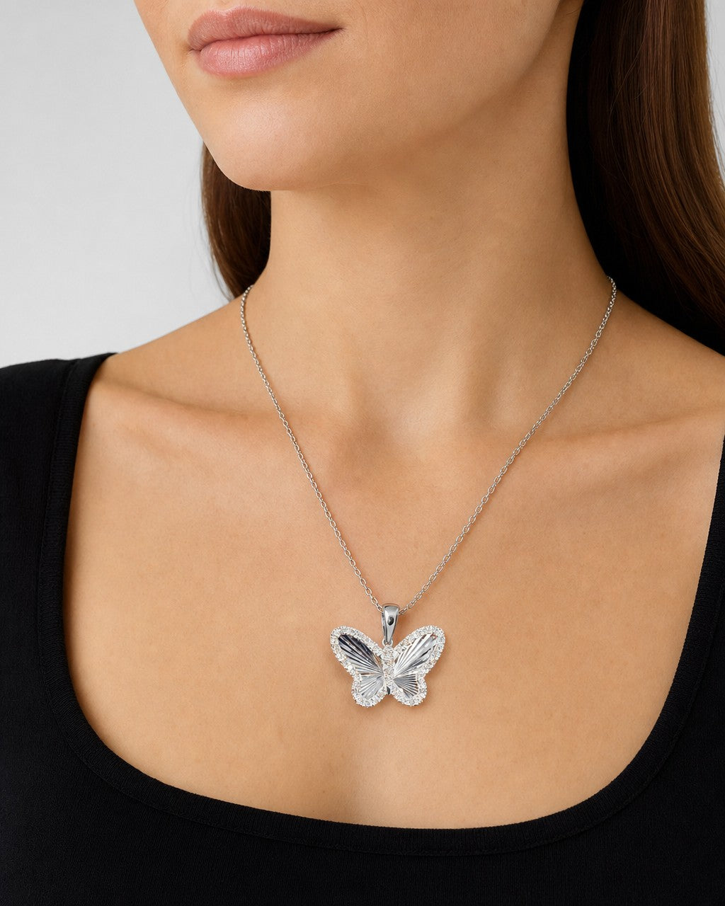 Female model wearing 14K Soft Butterfly Shine Diamond Pendant