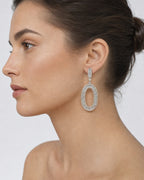 Female model wearing 14K Circle Hanging Diamond Baguette Earrings