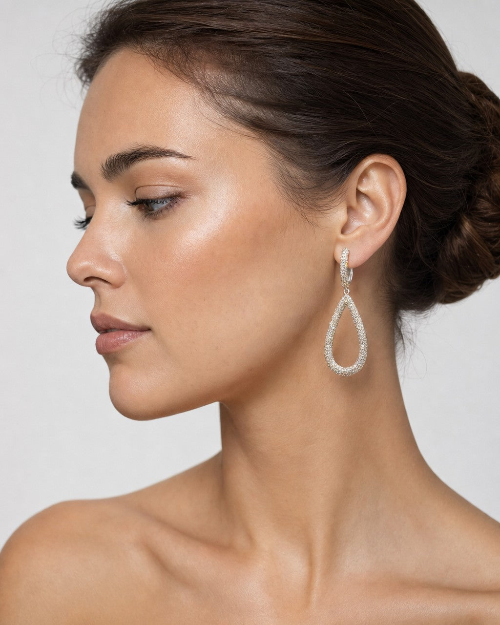 Female model wearing 14K Tear Drop Dangling Diamond Pave Earrings