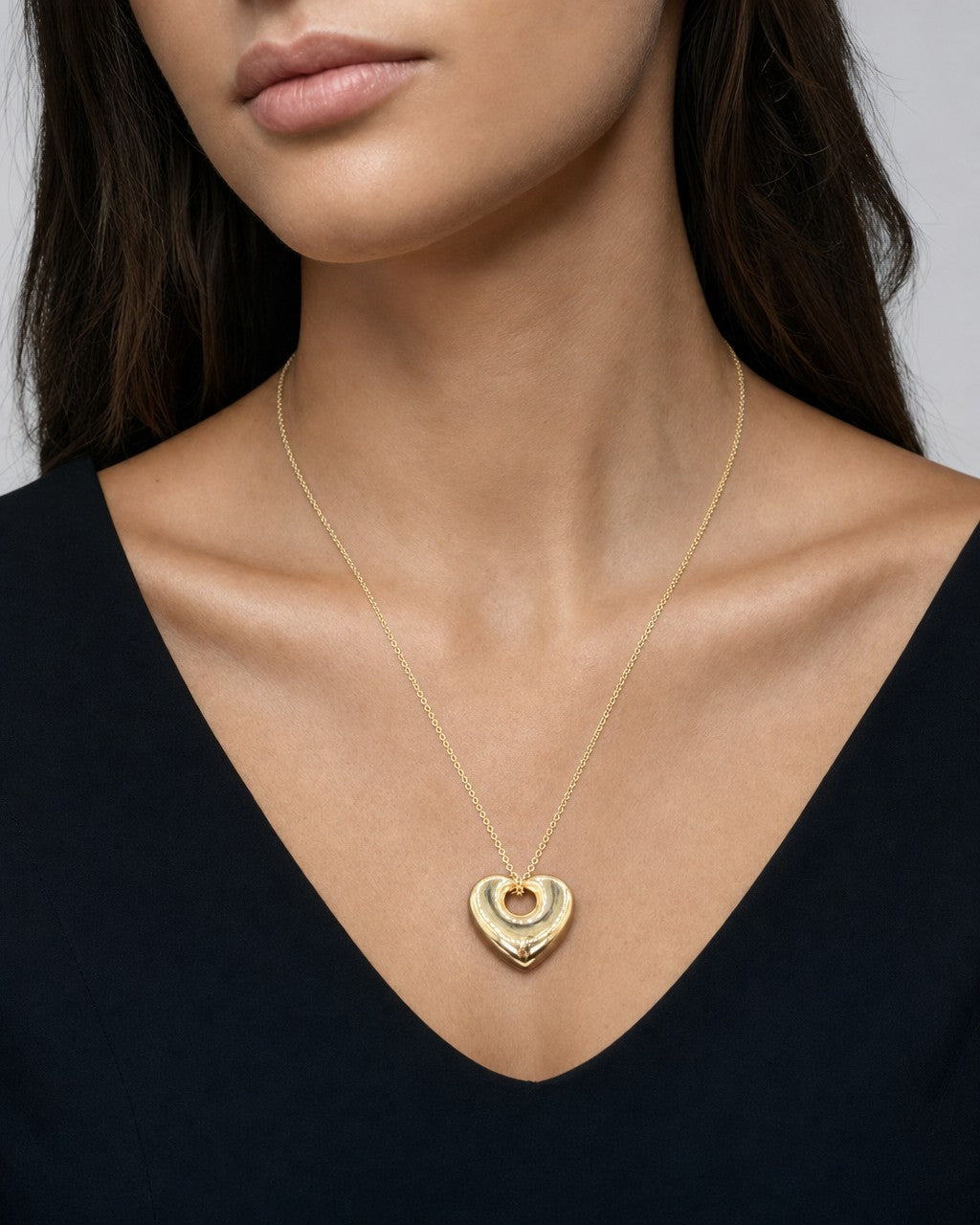 Female model wearing 14K Puffy Heart Charm Necklace