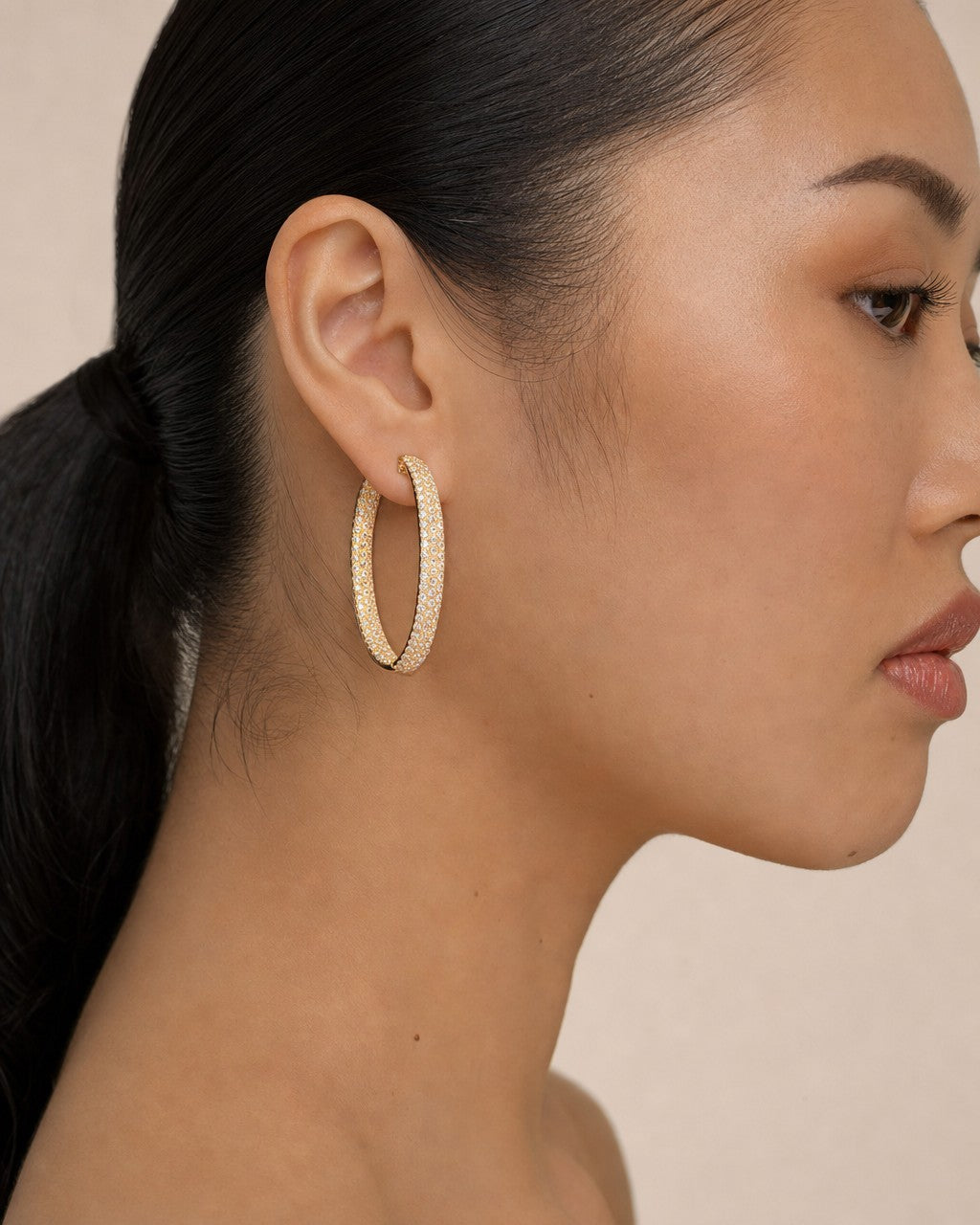 Female model wearing 14K Goddess Hoop Diamond Earrings