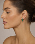 Female model wearing 18K Emerald Hoop Diamond Earrings