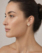 Female model wearing 14K 8MM Irving Rounded Square Diamond Earrings