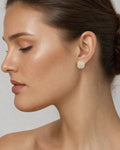 Female model wearing 14K 8MM Marcia Rounded Square Diamond Earrings