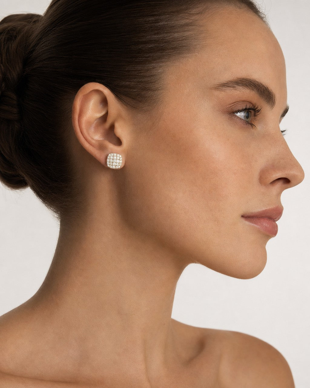 Female model wearing 14K 7MM Rounded Square Diamond Earrings