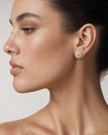 Female model wearing 14K 8.2MM Rounded Square Diamond Earrings